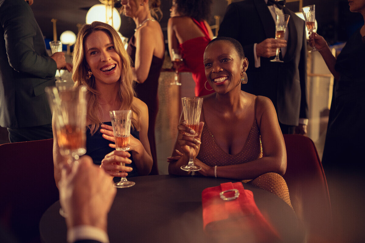 Guests in evening dress with champagne at a Cunard Gala Evening