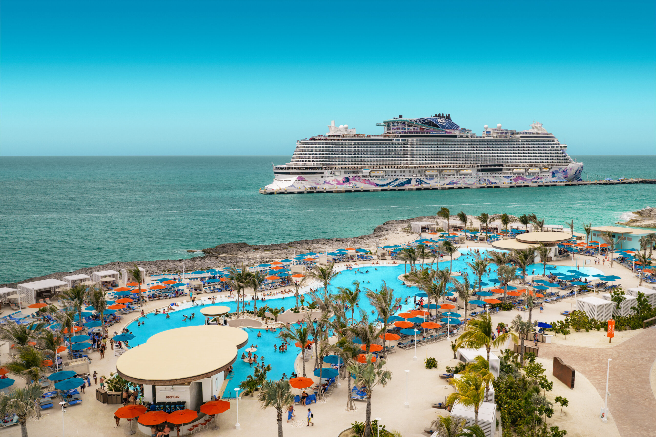 Families at the pool and beach on Great Stirrup Cay with Norwegian Luna offshore