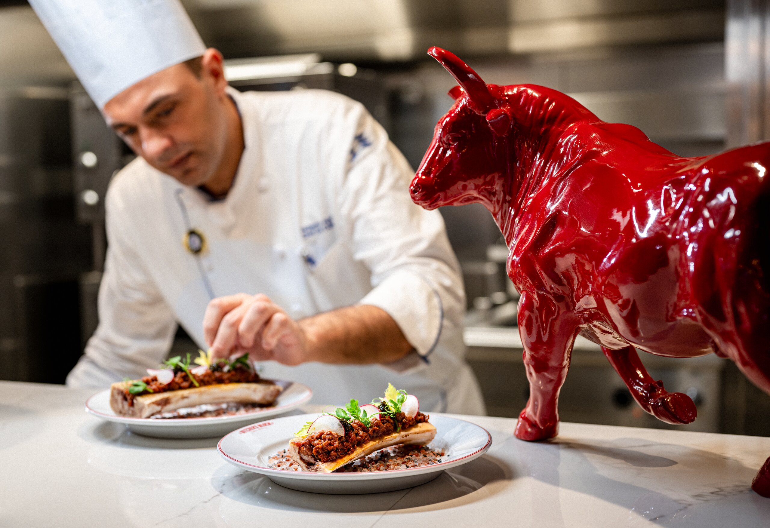 A chef plating steak at The Butcher's Block by Dario on Sun Princess