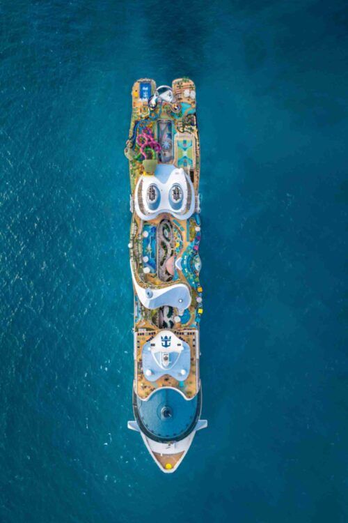 Royal Caribbean cruise ship sailing across the ocean at sunset, showcasing its multi-deck design, outdoor activities, and luxurious amenities Royal Caribbean cruise ship sailing across the ocean at sunset, showcasing its multi-deck design, outdoor activities, and luxurious amenities